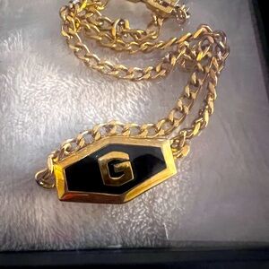 AUTHENTIC Givenchy necklace with black and gold G centered emblem with COA